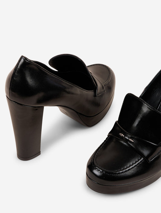 Heeled loafers in black patent leather