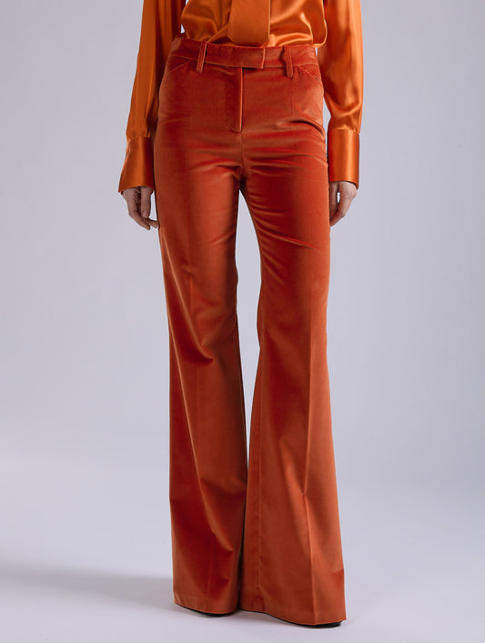 Orange velvet flare trousers