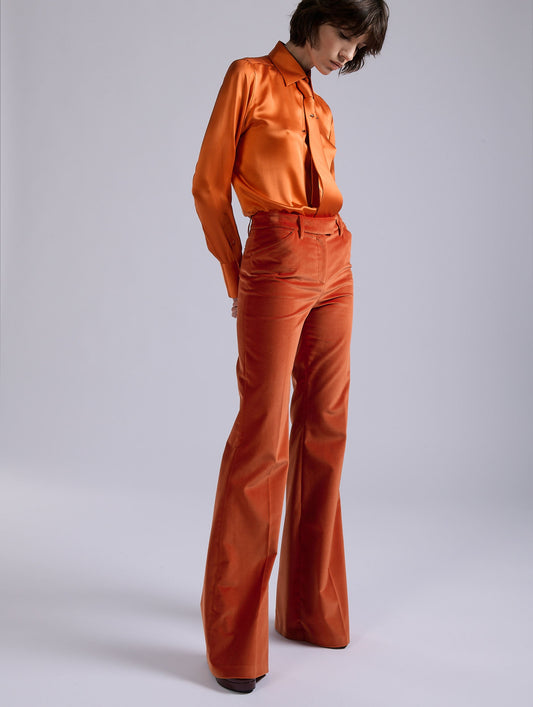 Orange velvet flare trousers