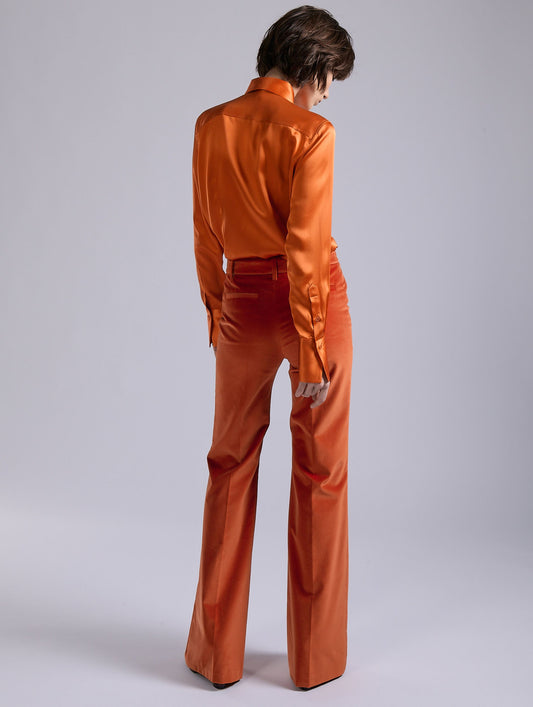 Orange velvet flare trousers
