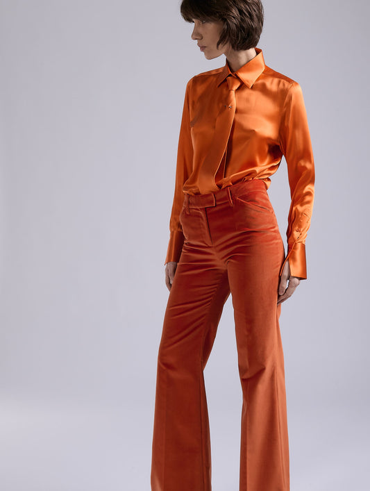 Orange velvet flare trousers