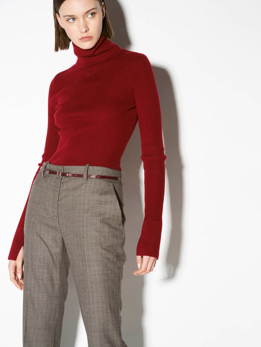 Red merino knit rollneck sweater with piercing detail