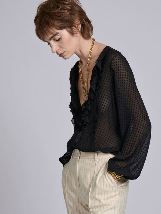 Black ruffled blouse in jacquard plumetis