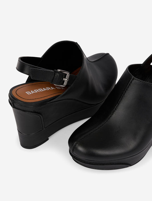 Black leather wedge clogs